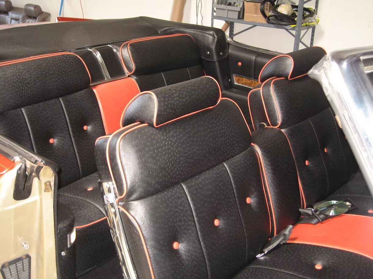 The inside of a car with black and red seats