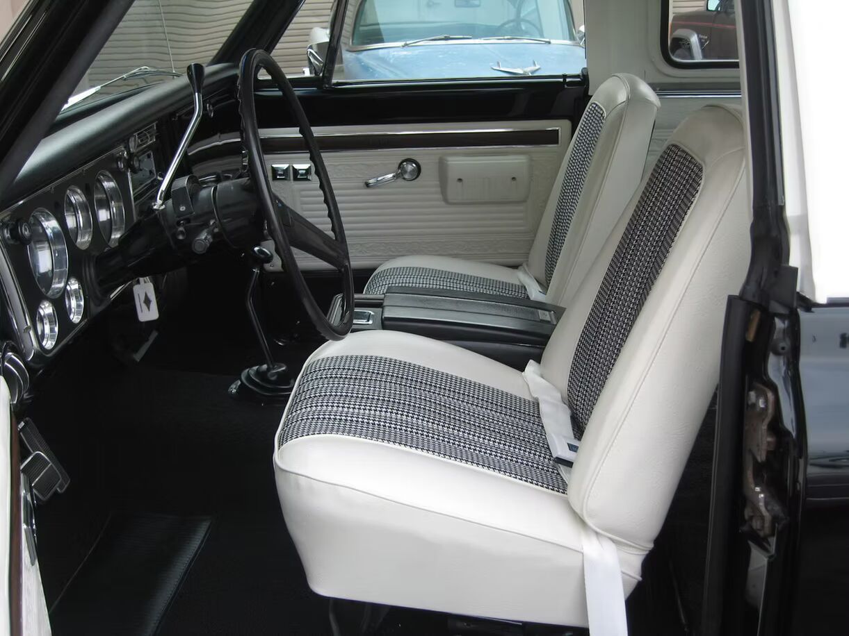 A black car with white seats and a steering wheel