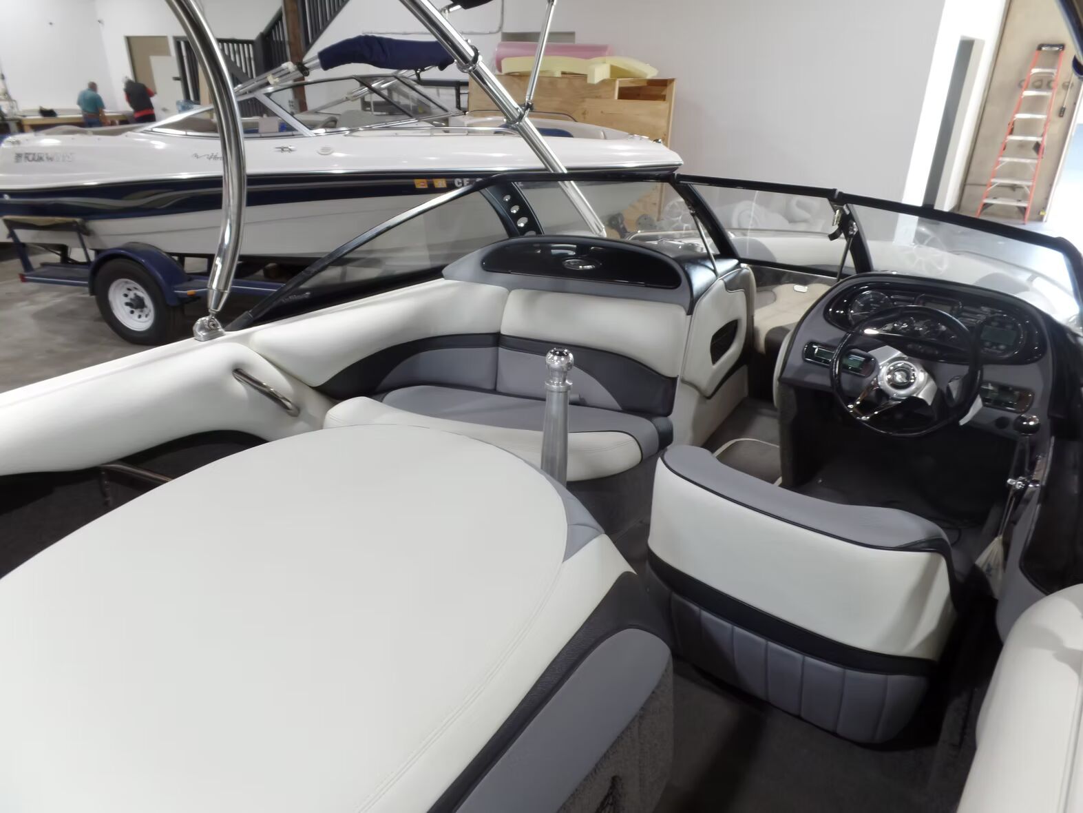 The inside of a boat with a steering wheel