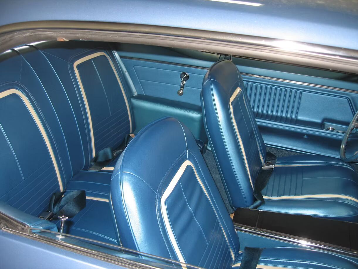 The inside of a blue car with blue seats