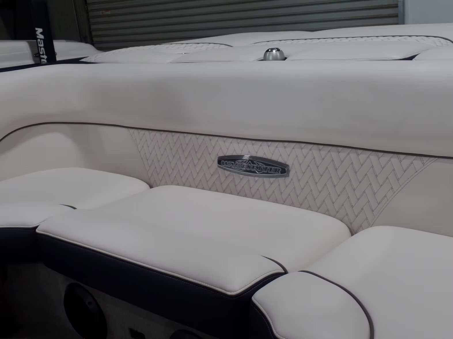 A white boat with a mastercraft logo on the side