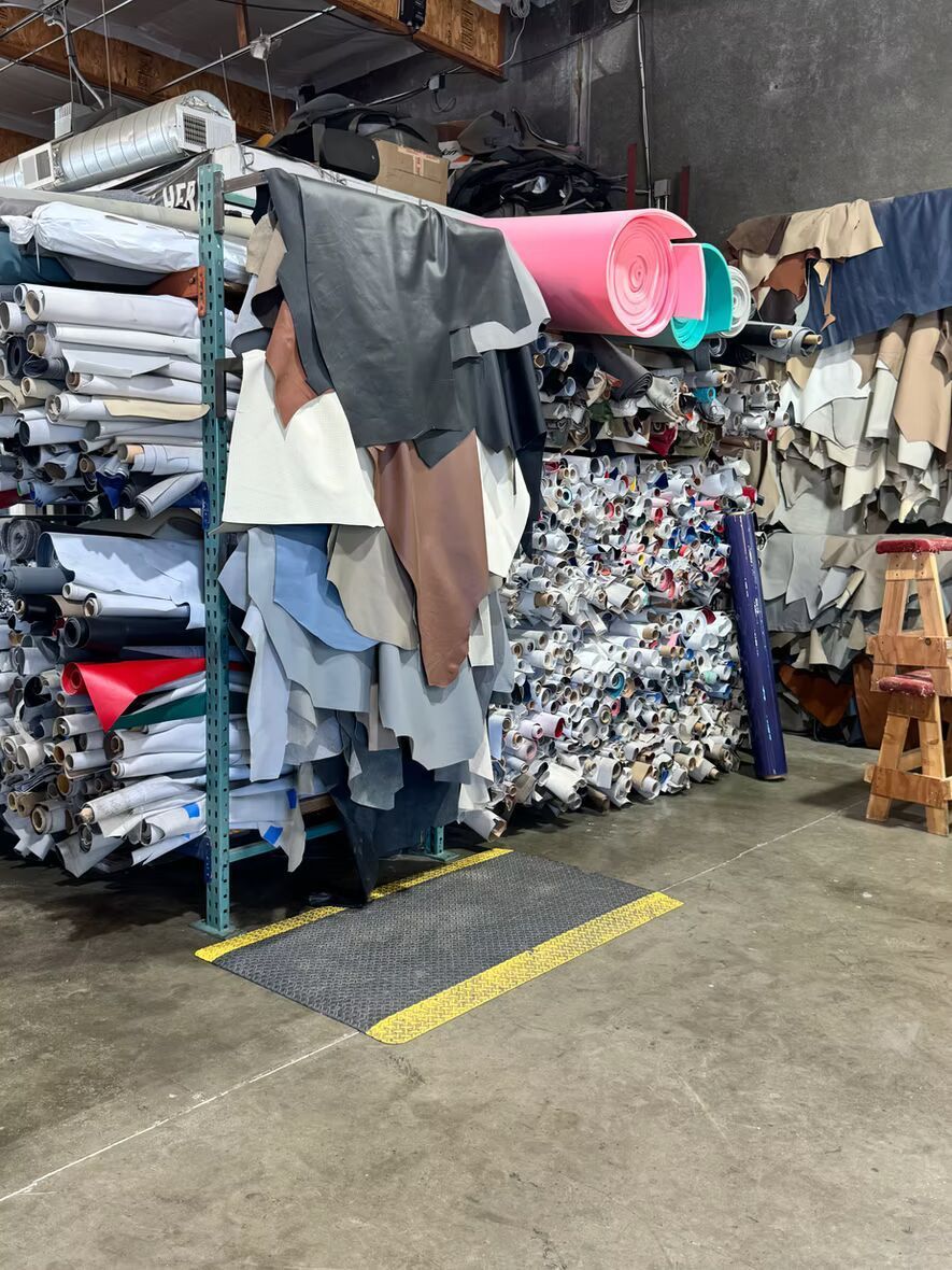 A warehouse filled with lots of different types of fabrics.