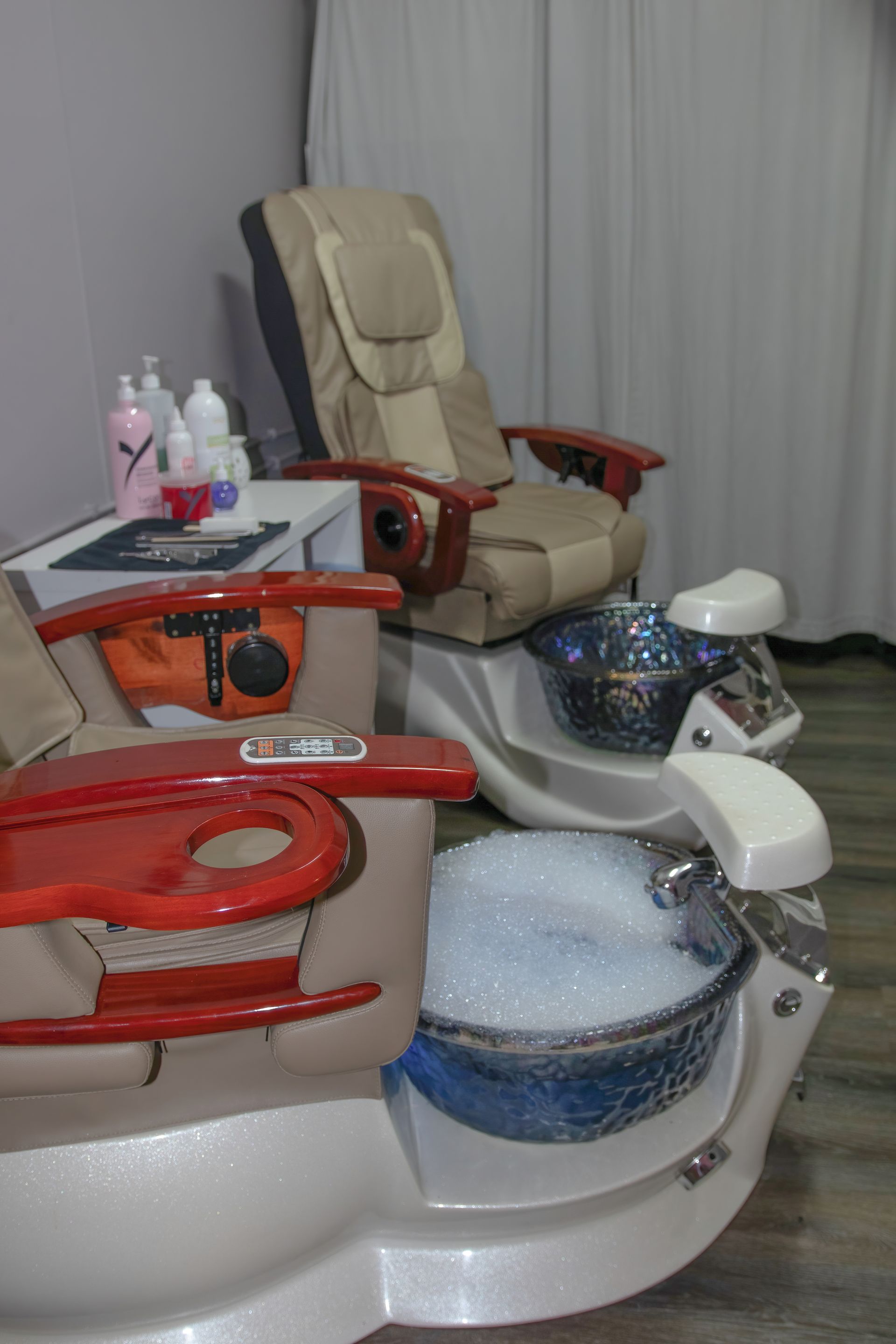 Two pedicure chairs with foot baths in a spa setting. One has bubbles.  — Admire Skincare and Beauty in Taree, NSW