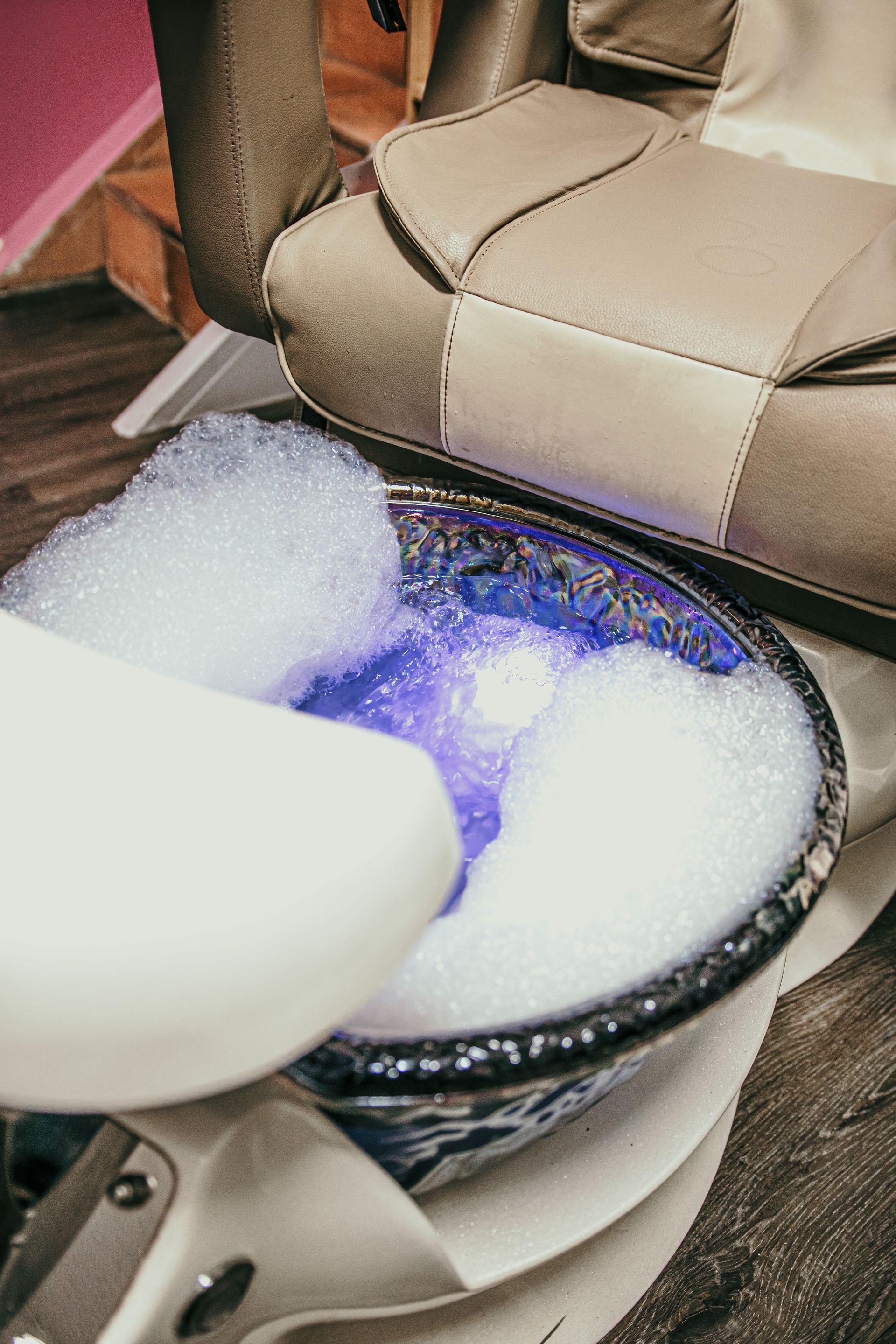 Pedicure foot spa bowl with bubbles, blue water, and chair. — Admire Skincare and Beauty in Taree, NSW
