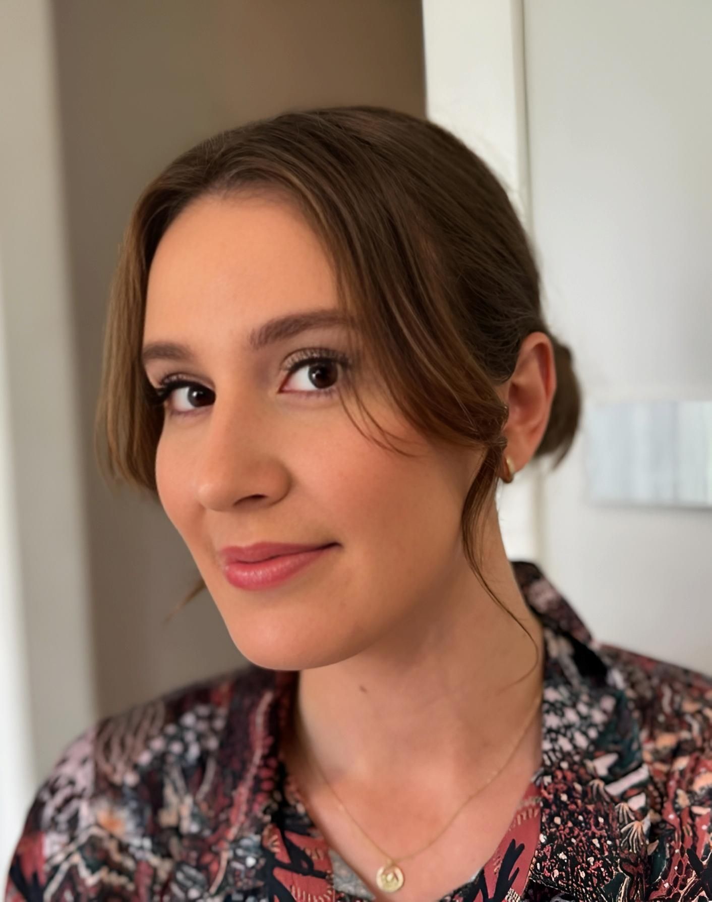 Woman With Brown Hair in a Bun, Wearing a Patterned Shirt — Admire Skincare and Beauty in Taree, NSW