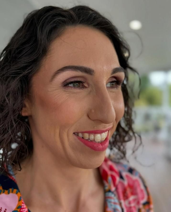 Woman With Dark Curly Hair and Pink Lipstick — Admire Skincare and Beauty in Taree, NSW
