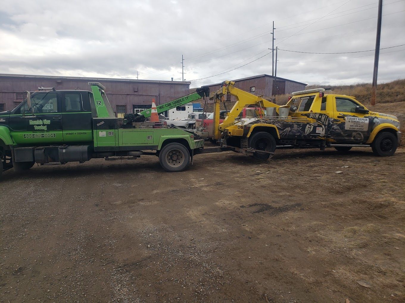 Red car being loaded onto a tow truck at sunset.