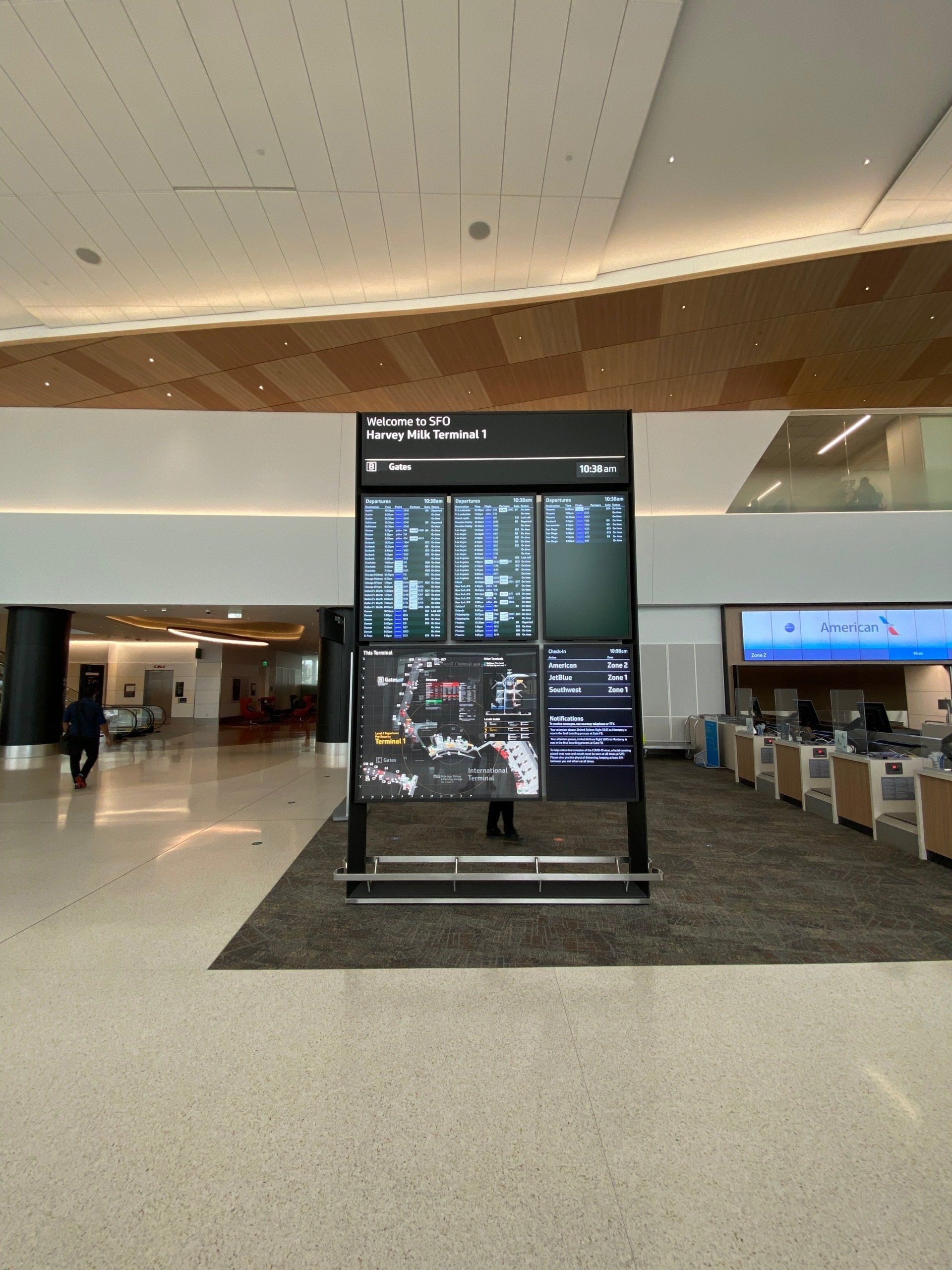Photo of a departure and arrival board at the SF airport terminal.