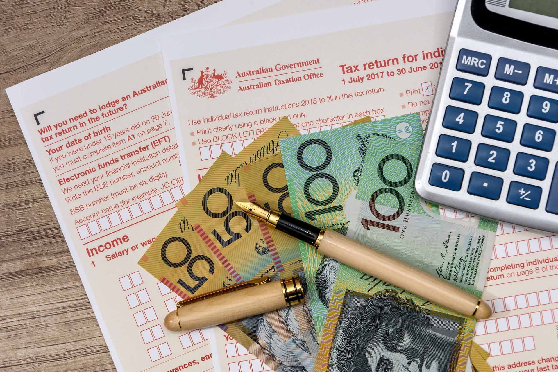 Australian dollars with calculator and tax form | Perth, WA | LG Accounting Solutions