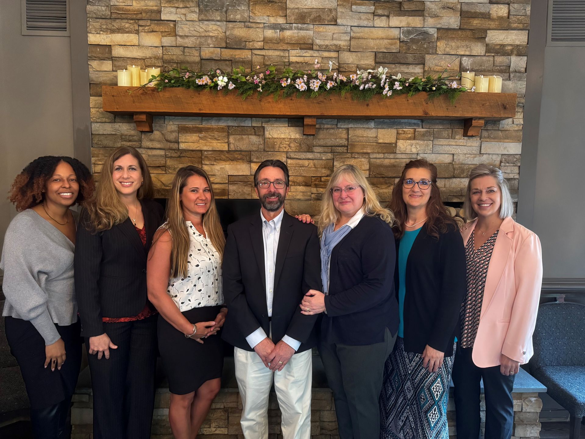 The Horne Insurance Agency team members are posing for a picture in a hallway.
