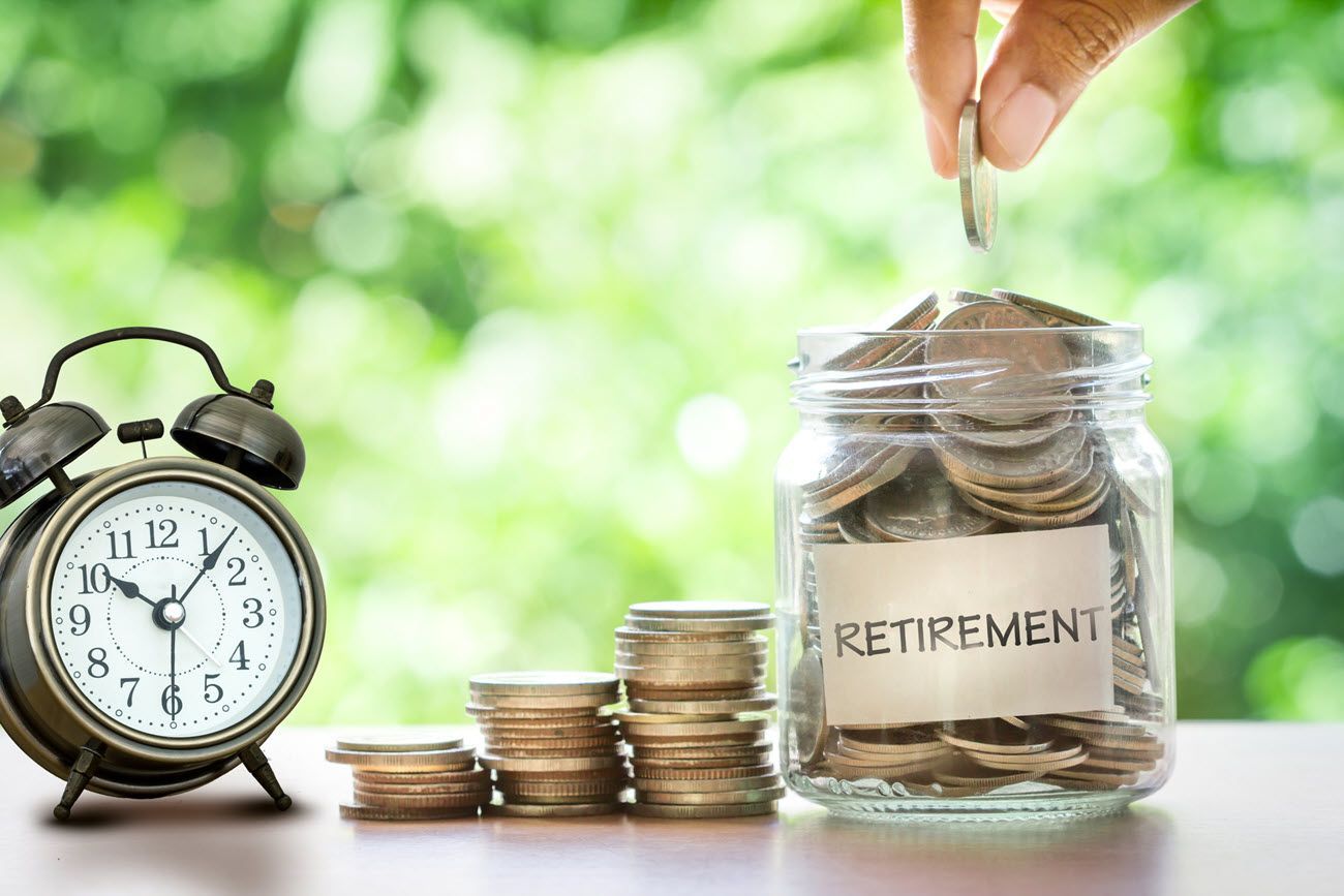 Hand dropping coin into jar labeled
