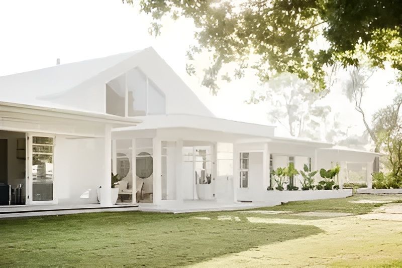 A White House with A Large Lawn in Front of It — Taree Paint Centre in Taree, NSW
