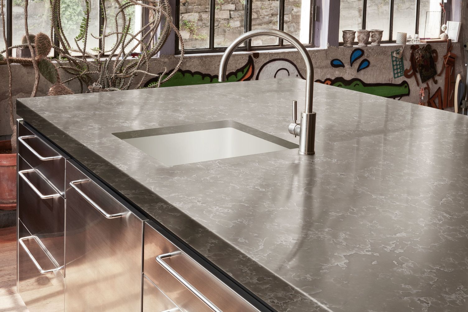 A kitchen counter with a sink and a faucet on it