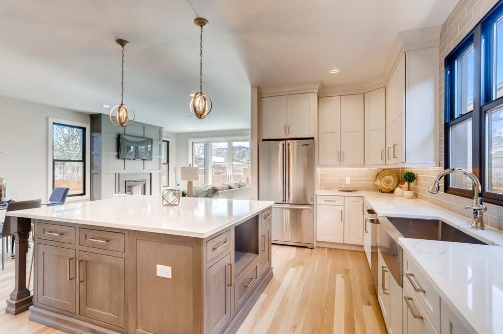 A kitchen with stainless steel appliances and a large island in the middle