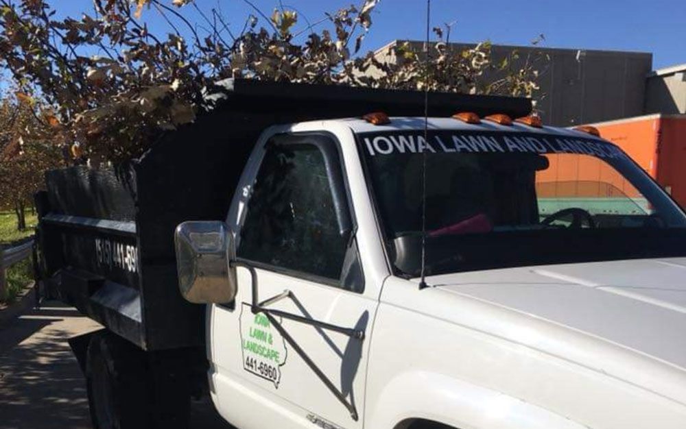 A white truck is parked on the side of the road.