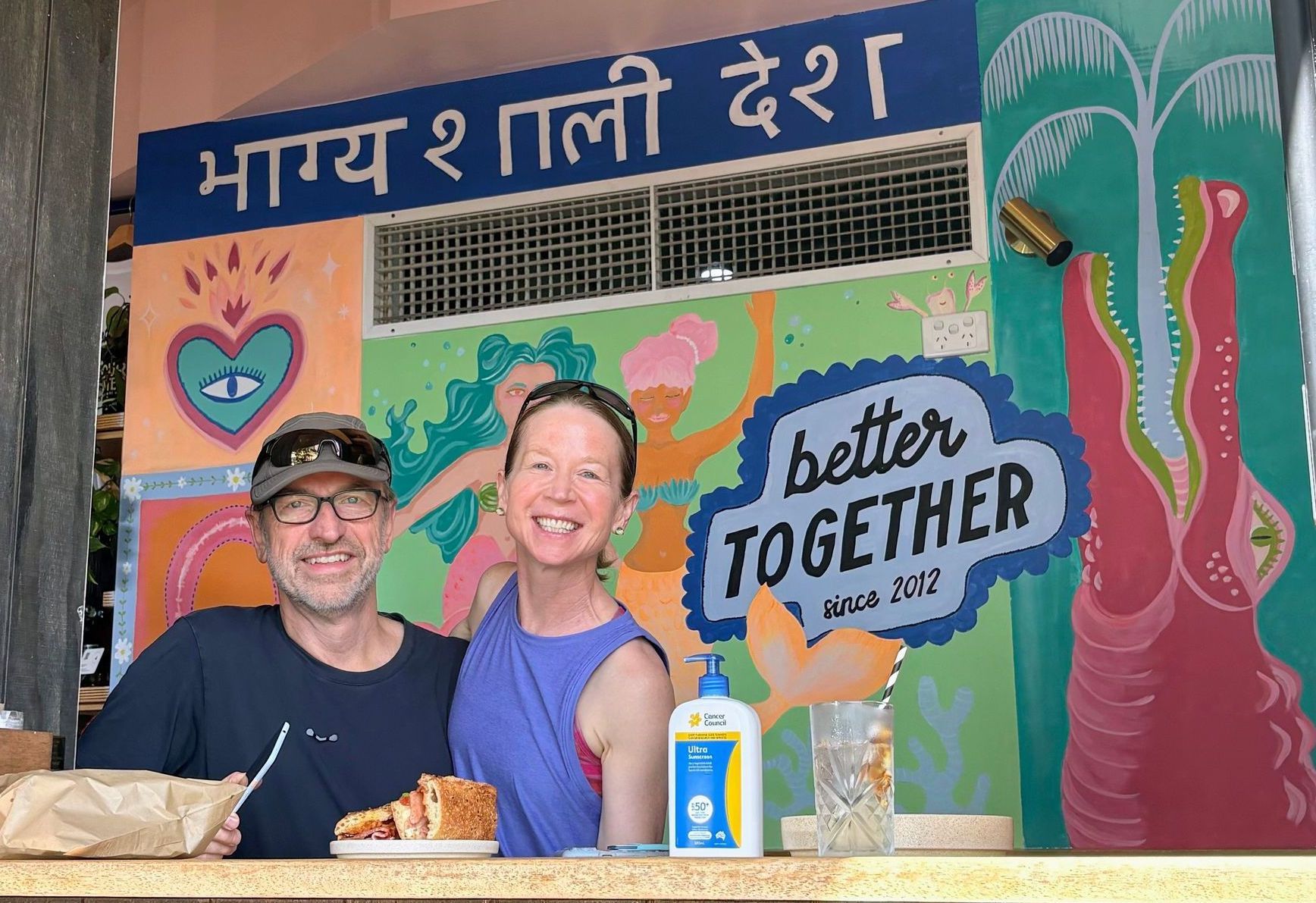 Jerry Michalski and April Rinne are standing in front of a sign that says better together