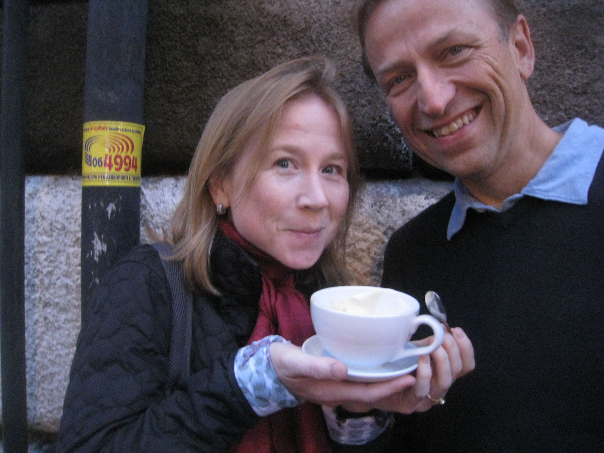 Jerry Michalski and April Rinne are holding a cup of coffee and smiling