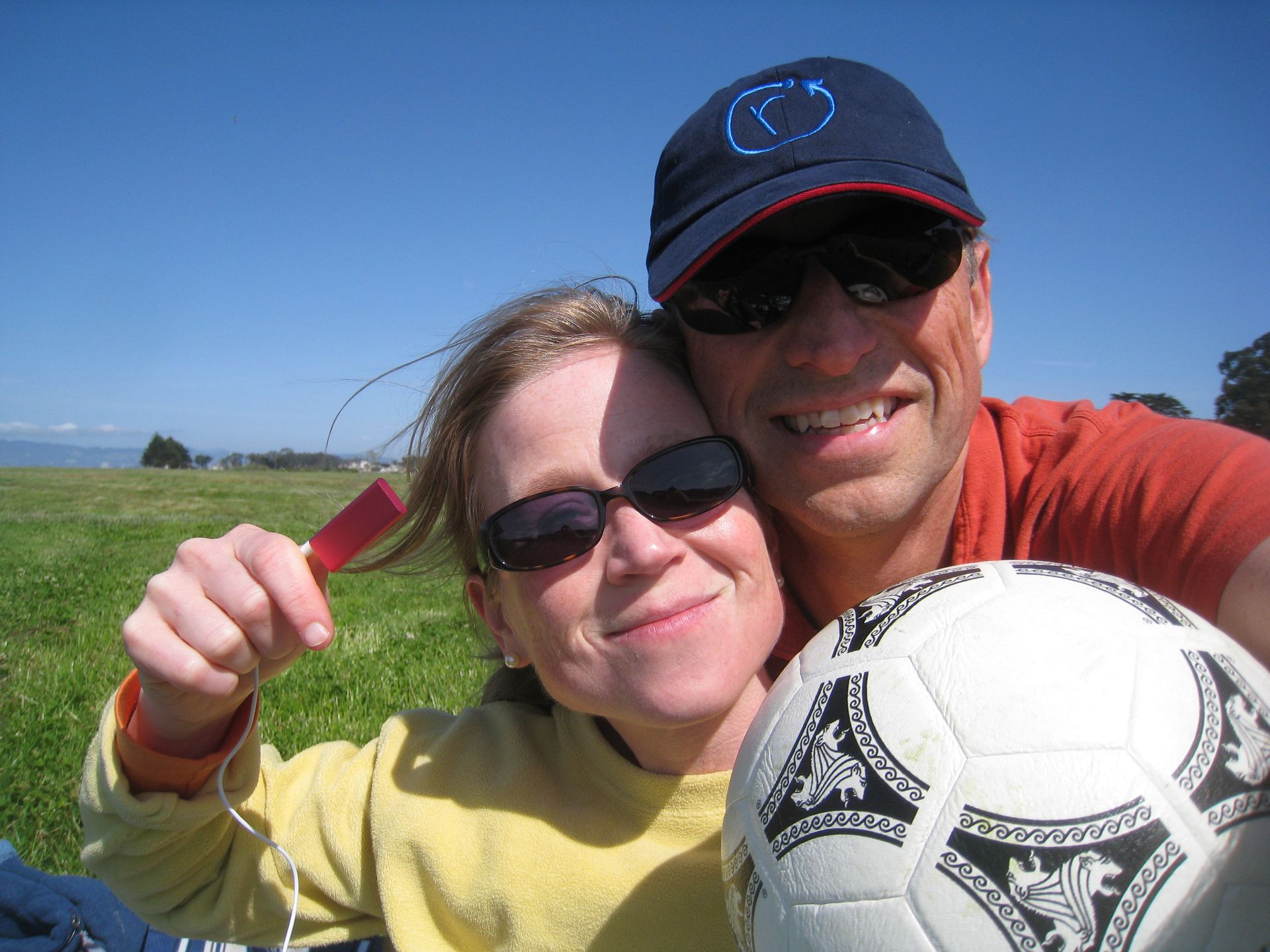 Jerry Michalski and April Rinne are posing for a picture with a soccer ball