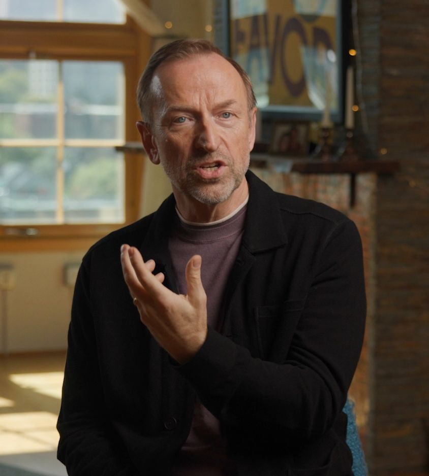 Jerry Michalski in a black jacket is talking to someone