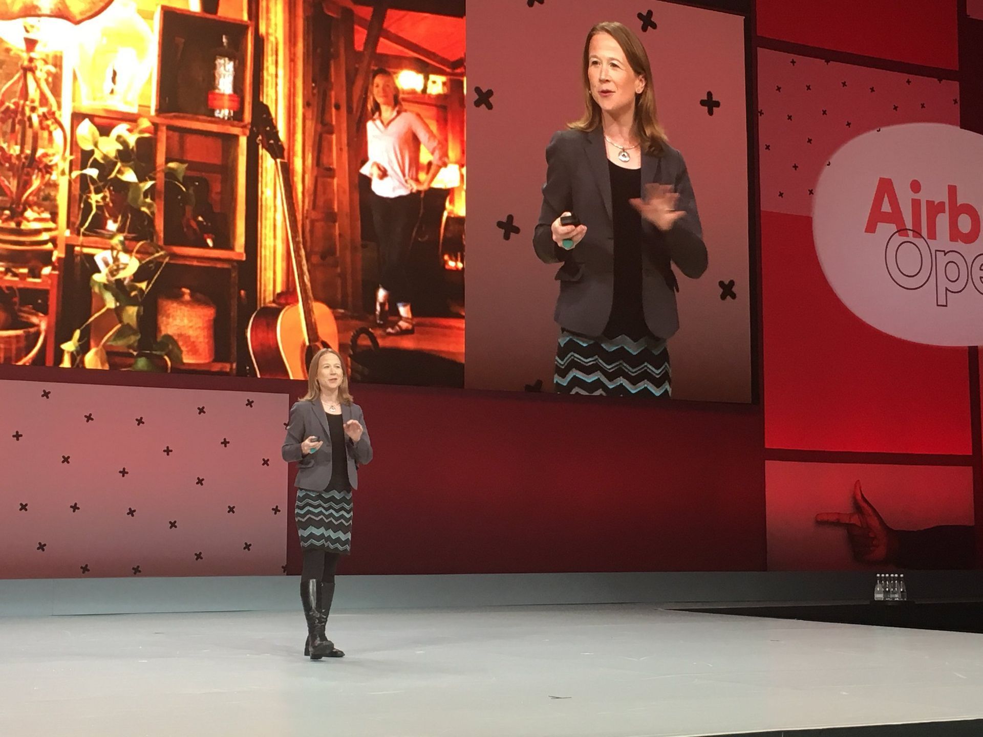 April Rinne stands on a stage in front of an airbnb sign