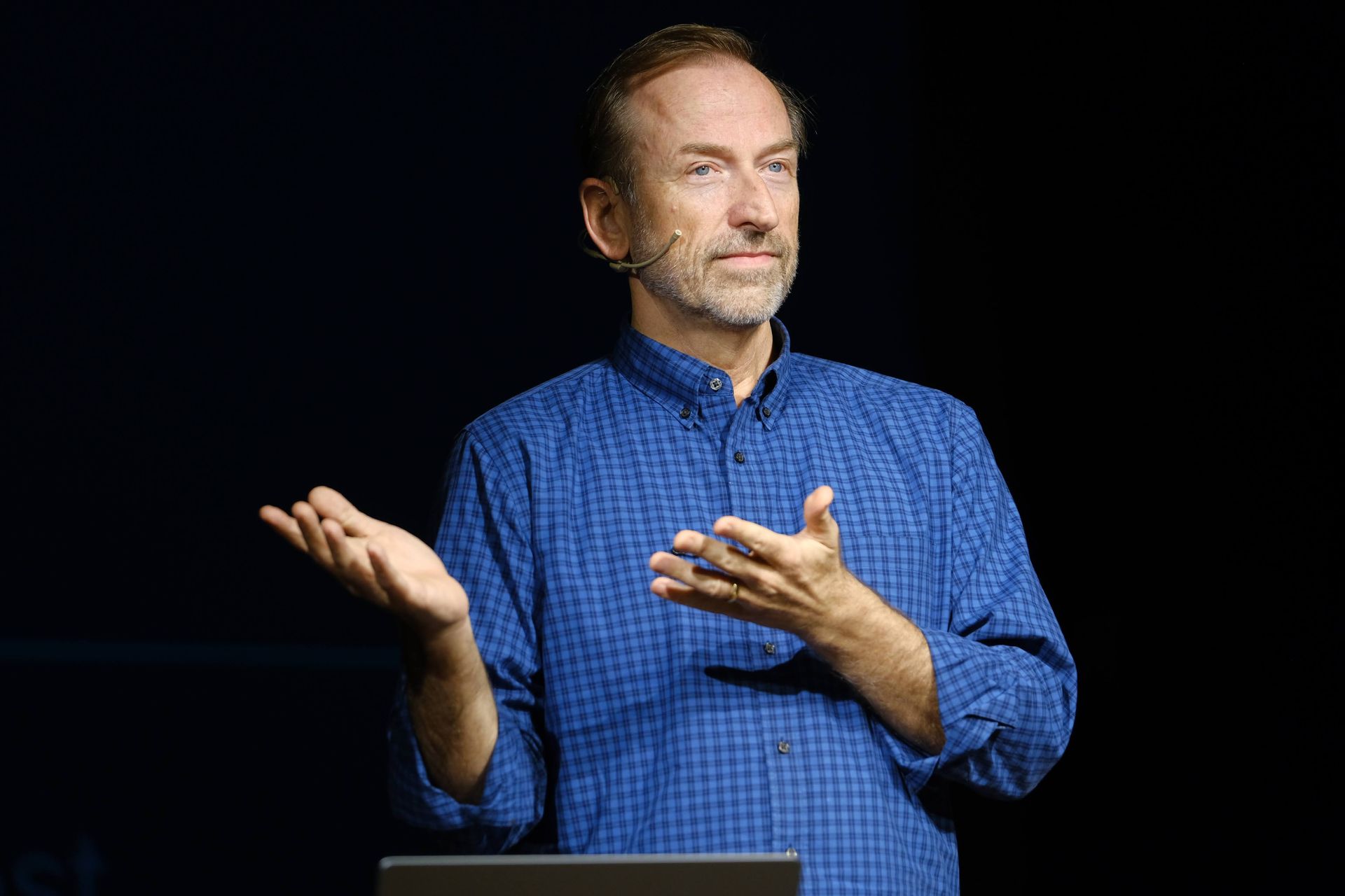 Jerry Michalski in a blue shirt is standing in front of a laptop computer.