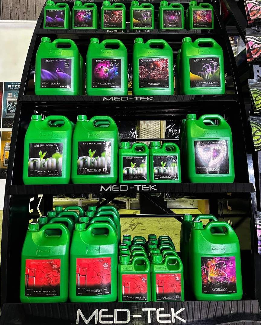 A Shelf Filled With Green Bottles of Med-tek Fertilizer — Wide Bay Hydroponics In Bundaberg, QLD