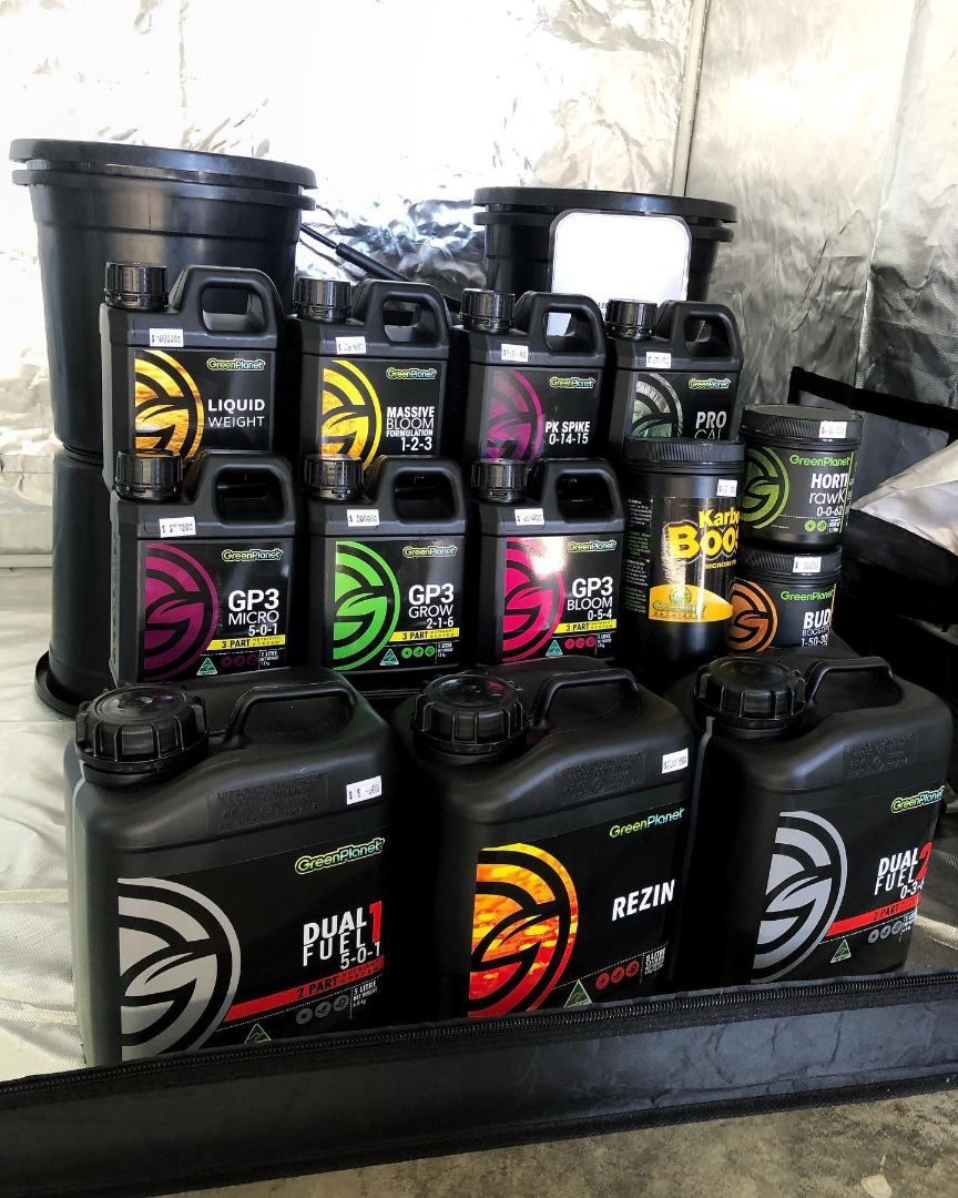 A Bunch of Bottles Sitting on Top of Each Other on a Table — Wide Bay Hydroponics In Bundaberg, QLD