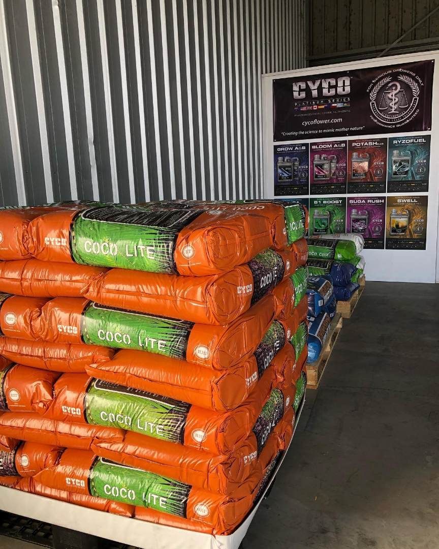 A Bunch of Bags of Plant Nutrients Are Stacked on Top of Each Other in a Store — Wide Bay Hydroponics In Maryborough, QLD