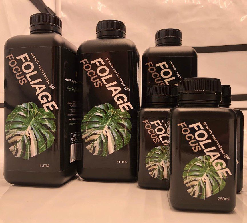 Four Bottles of Foliage Focus Are Sitting Next to Each Other on a Table — Wide Bay Hydroponics In Maryborough, QLD
