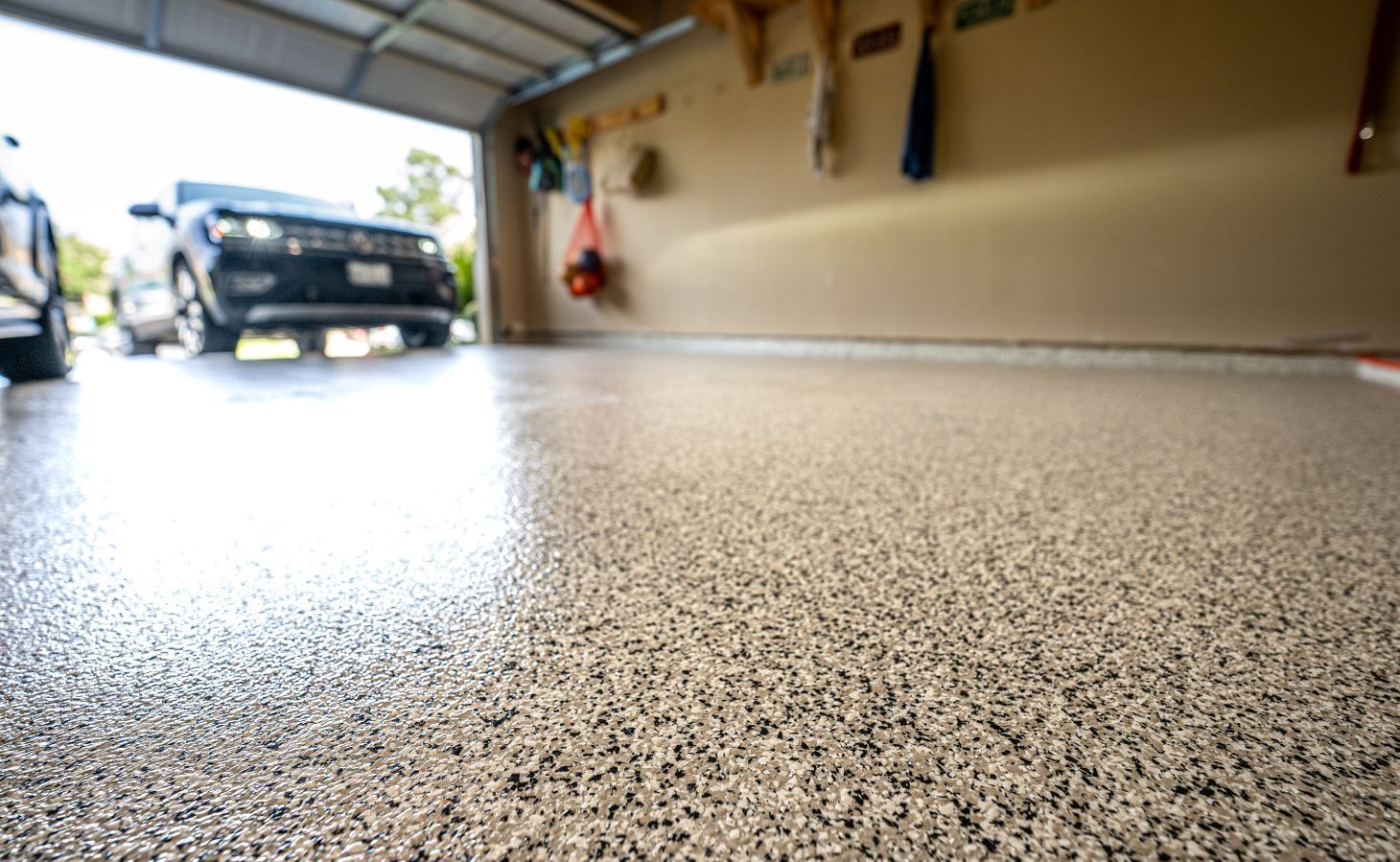 A car is parked in a garage with a concrete floor.