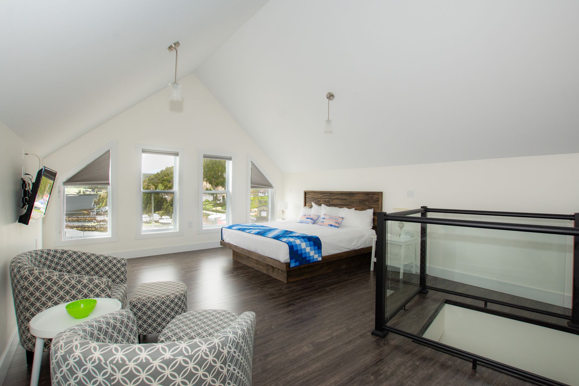 A bedroom with a king size bed and two chairs