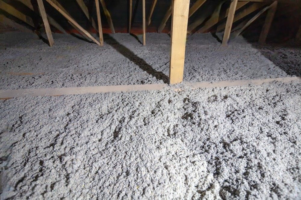 There is a lot of insulation in the attic of a house.
