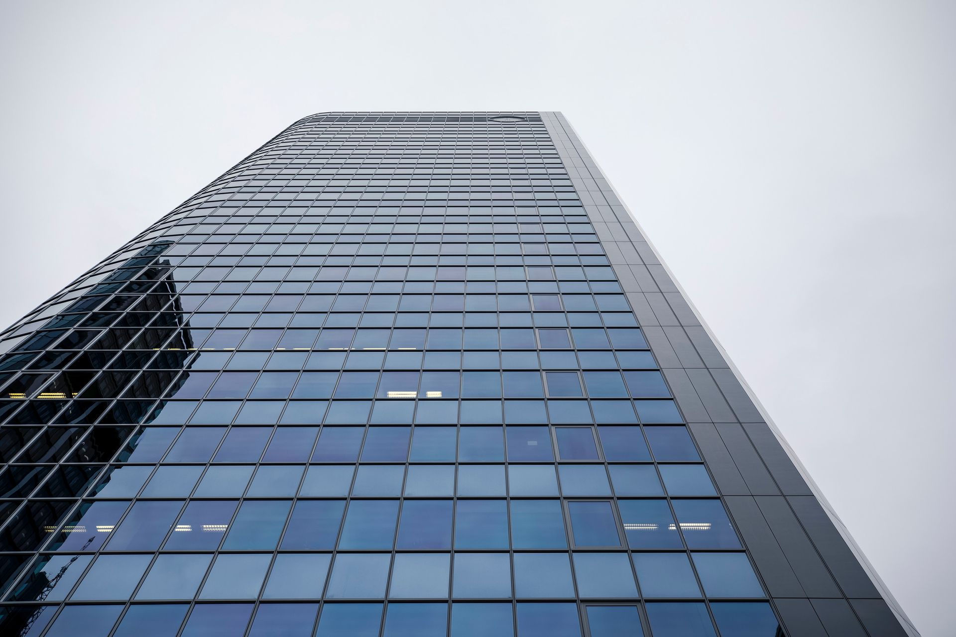 Looking up at a tall building with lots of windows