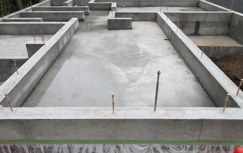 A concrete base for a house is being built.