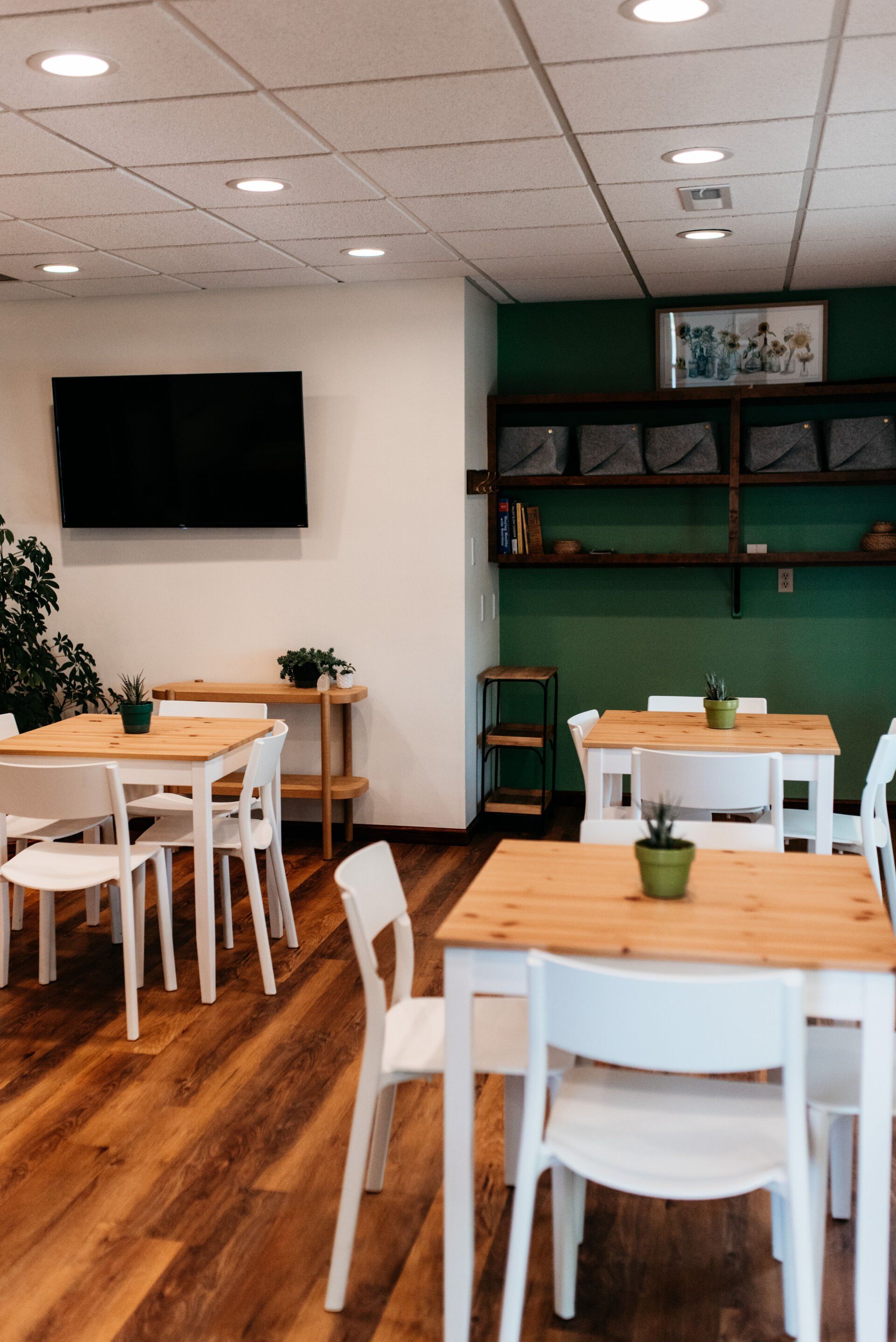 Professional photograph of the dining/breakroom with nice tables and chairs.