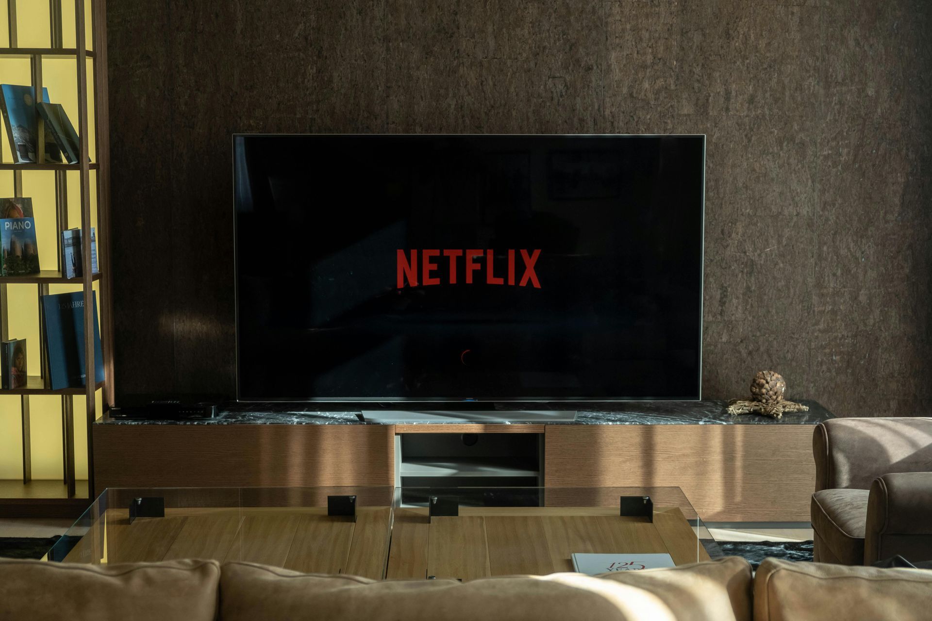 Netflix logo displayed on a large TV in a living room setting.