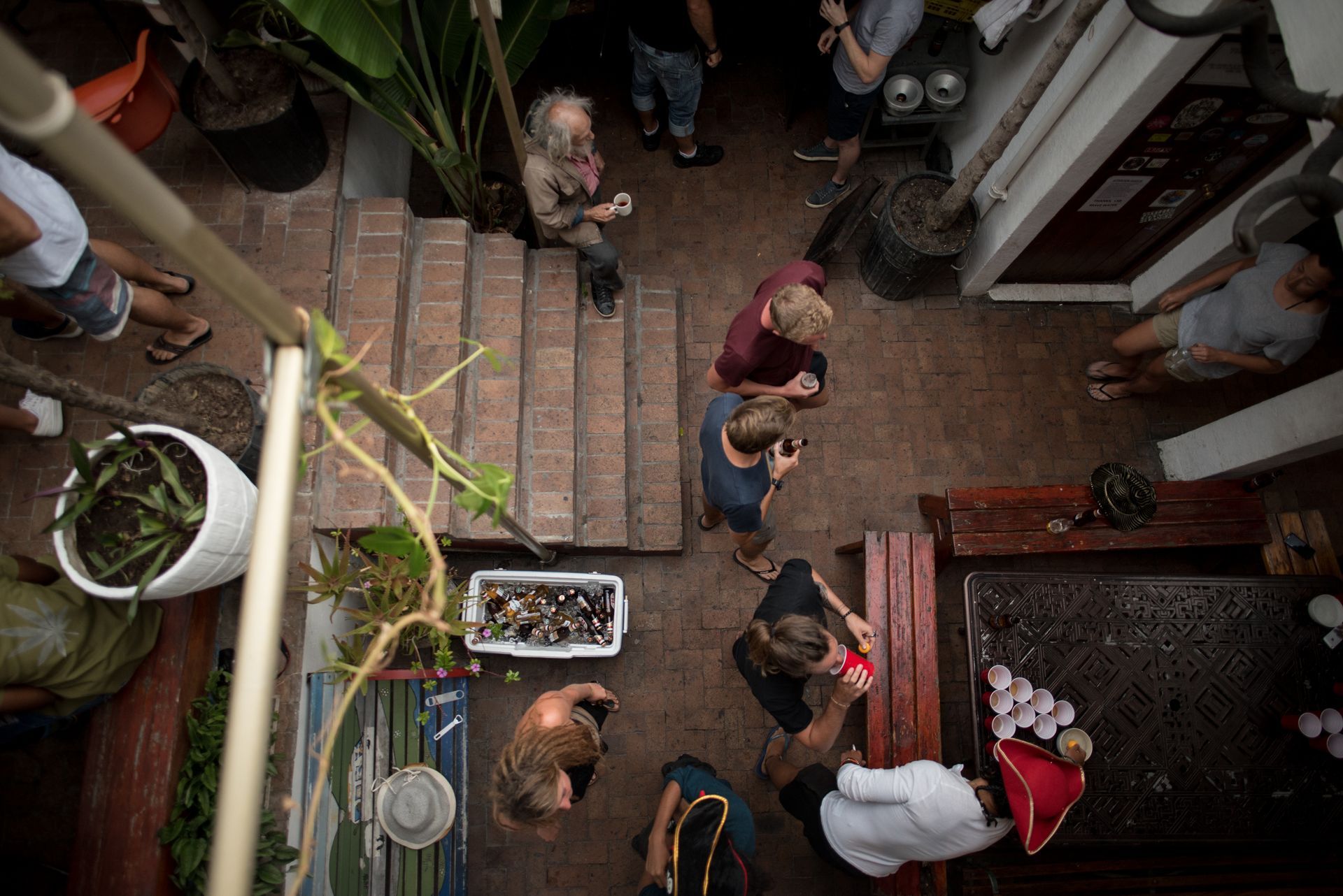 A group of people are standing around a table in a courtyard.