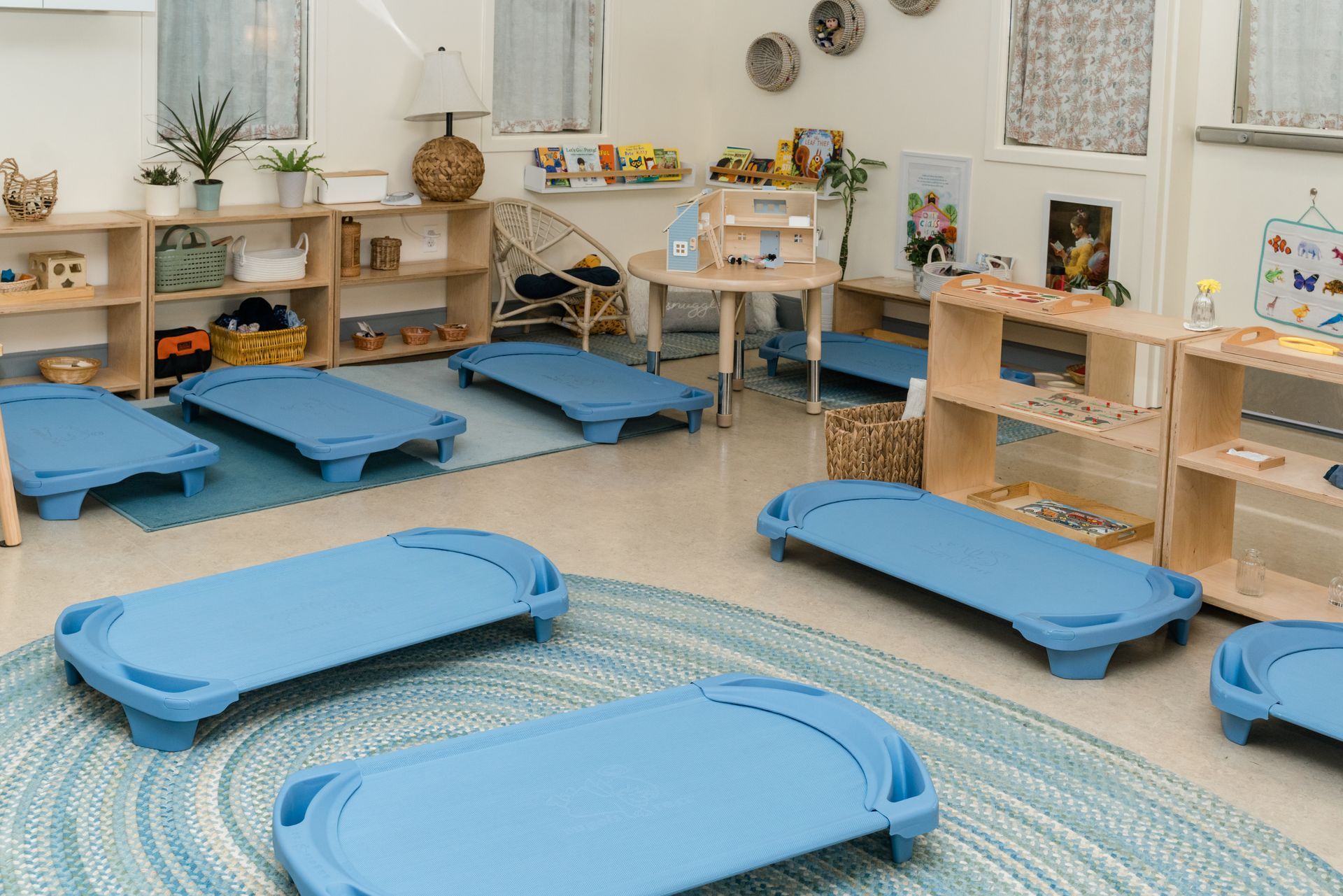 A room with montessori materials and a rug on the floor.