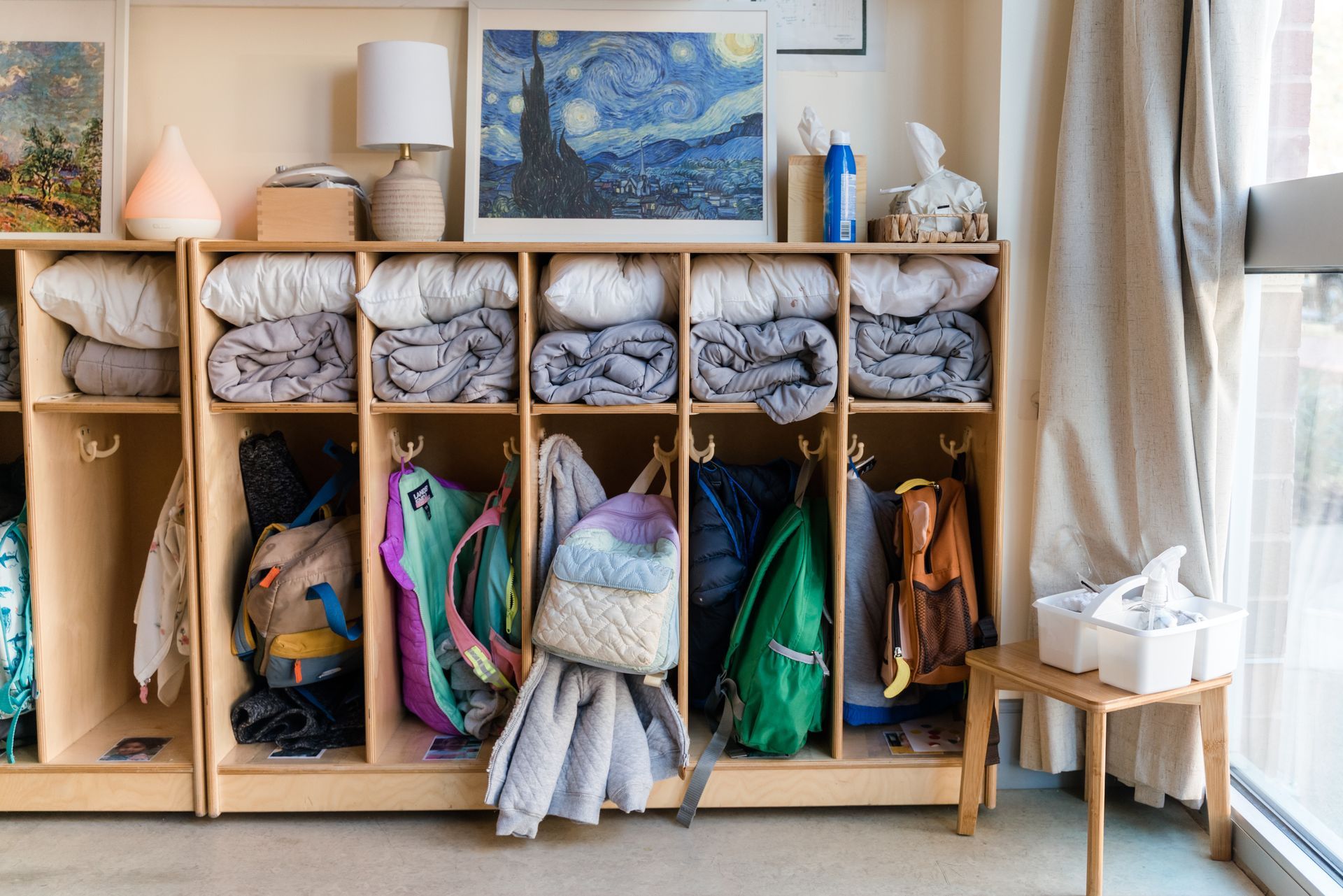 There is a starry night painting on the wall above the lockers.