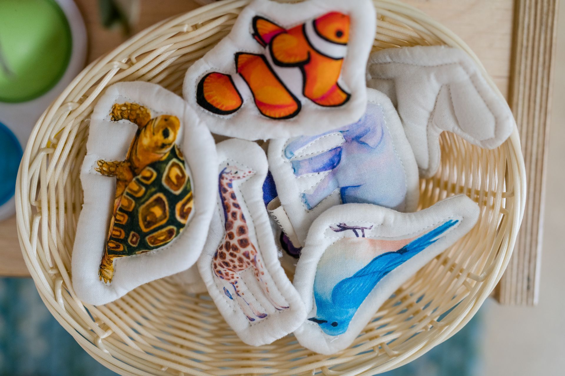 A basket filled with montessori materials stuffed animals.