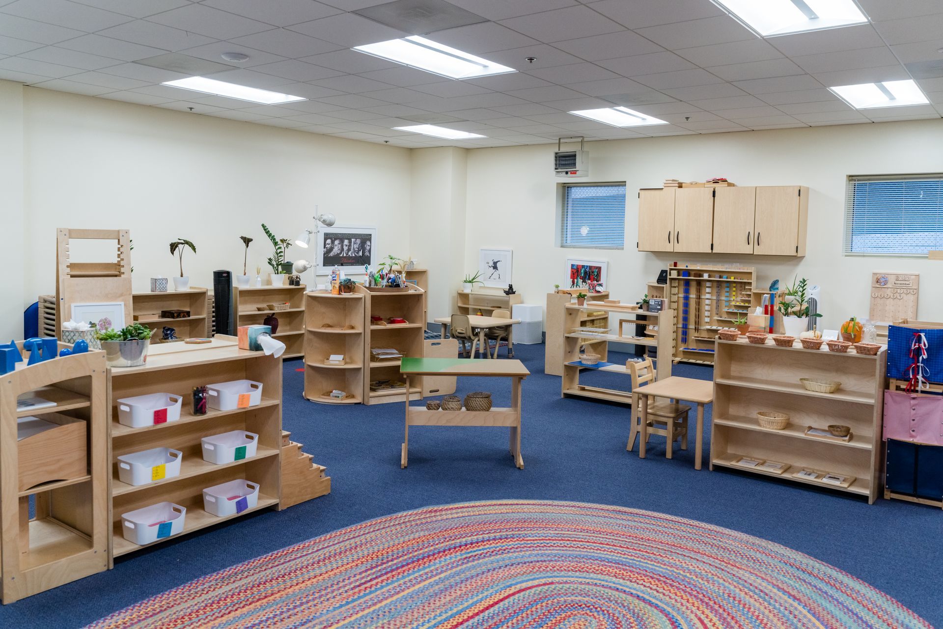 A montessori classroom filled with lots of shelves and toys.