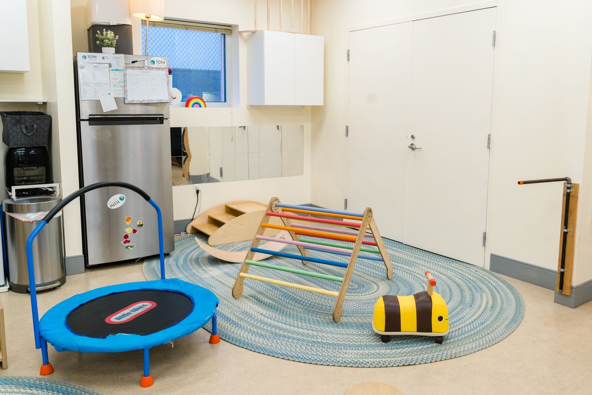 Montessori classroom with a trampoline in the middle of the room.