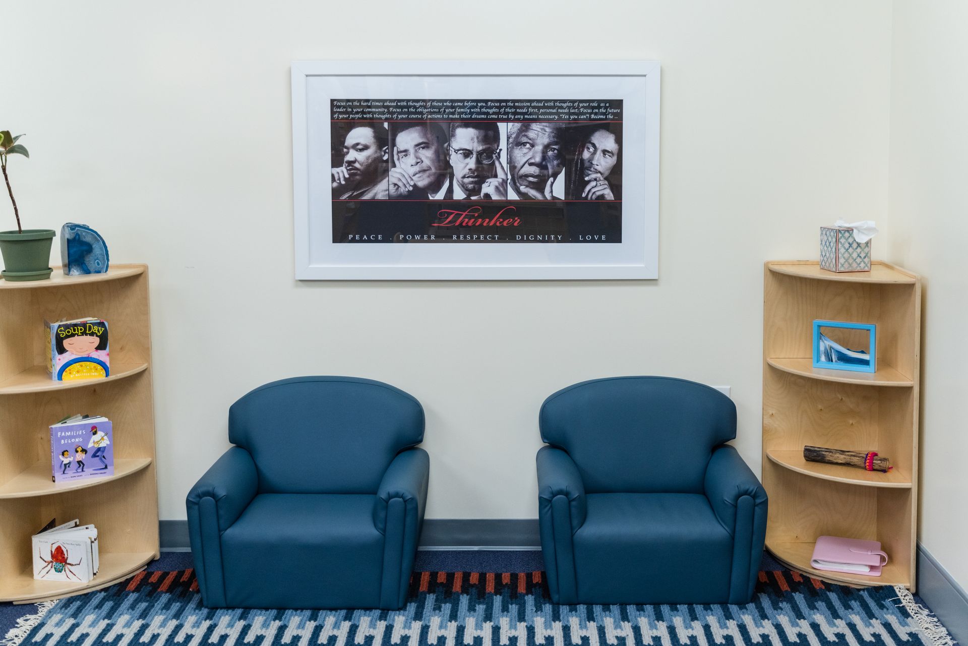 Monetssori room with two blue chairs and materials.