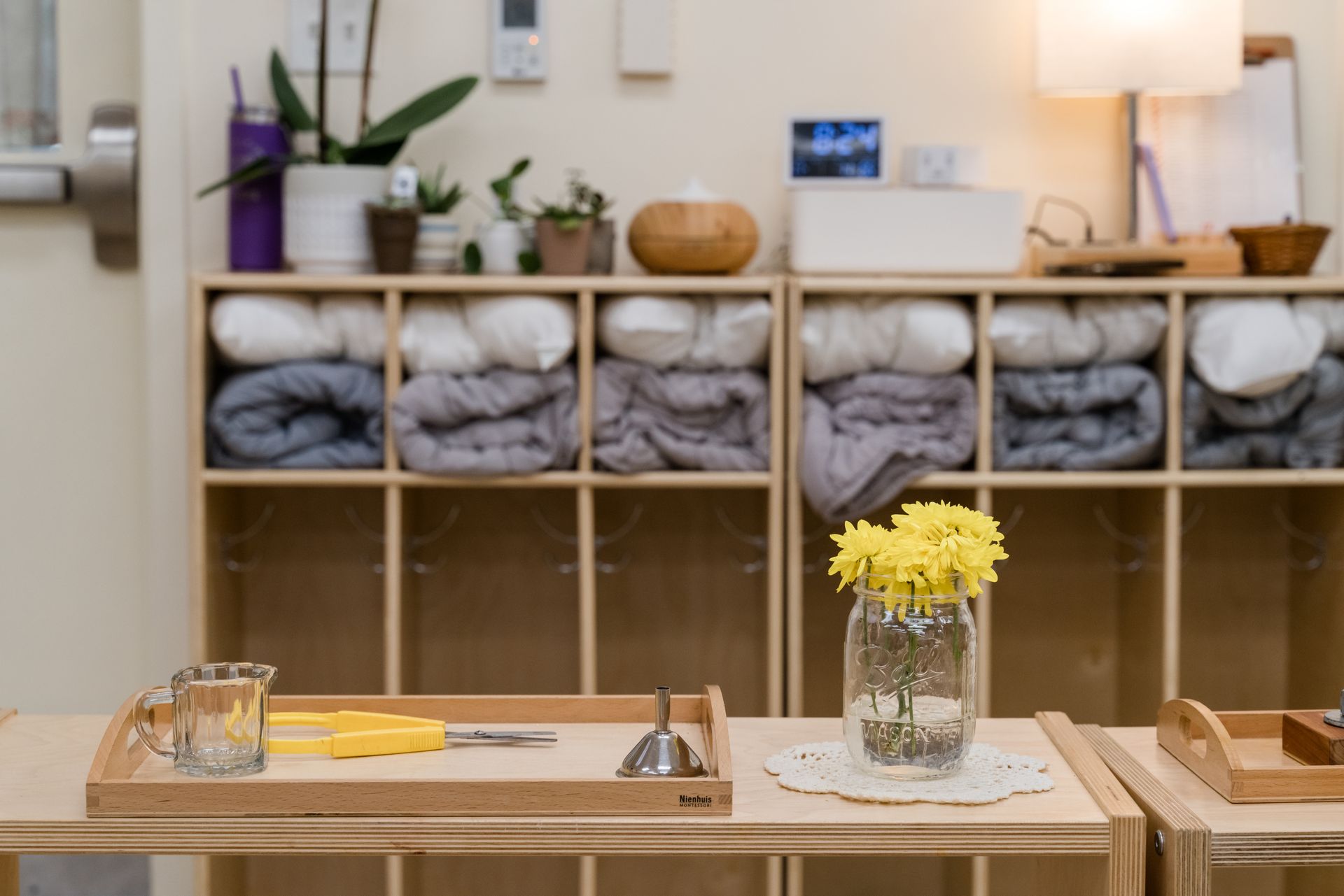 A table with a vase of flowers on it in a room.
