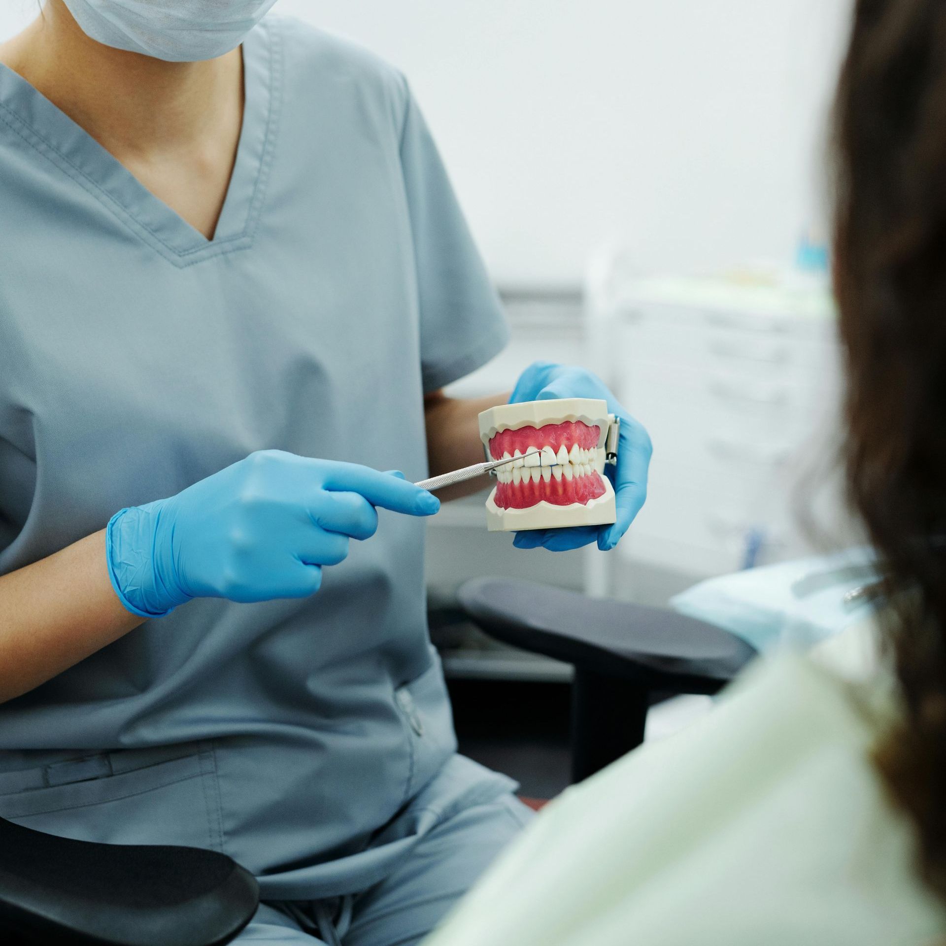 dentist explaining with model teeth