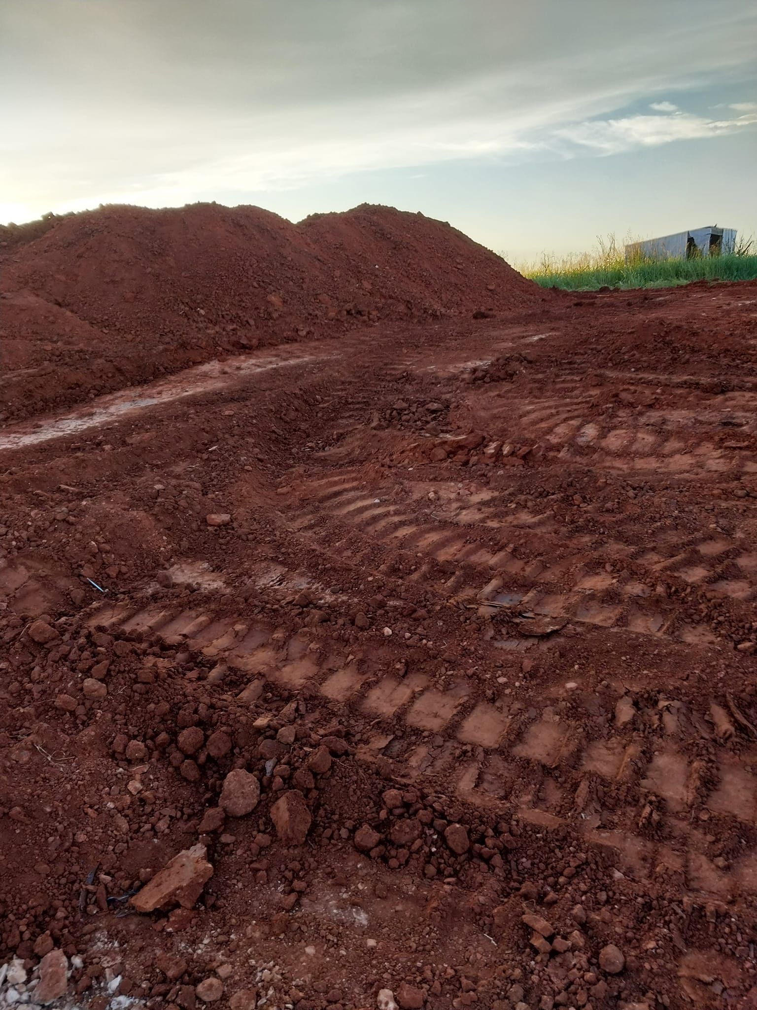 A pile of dirt is sitting on top of a dirt field.