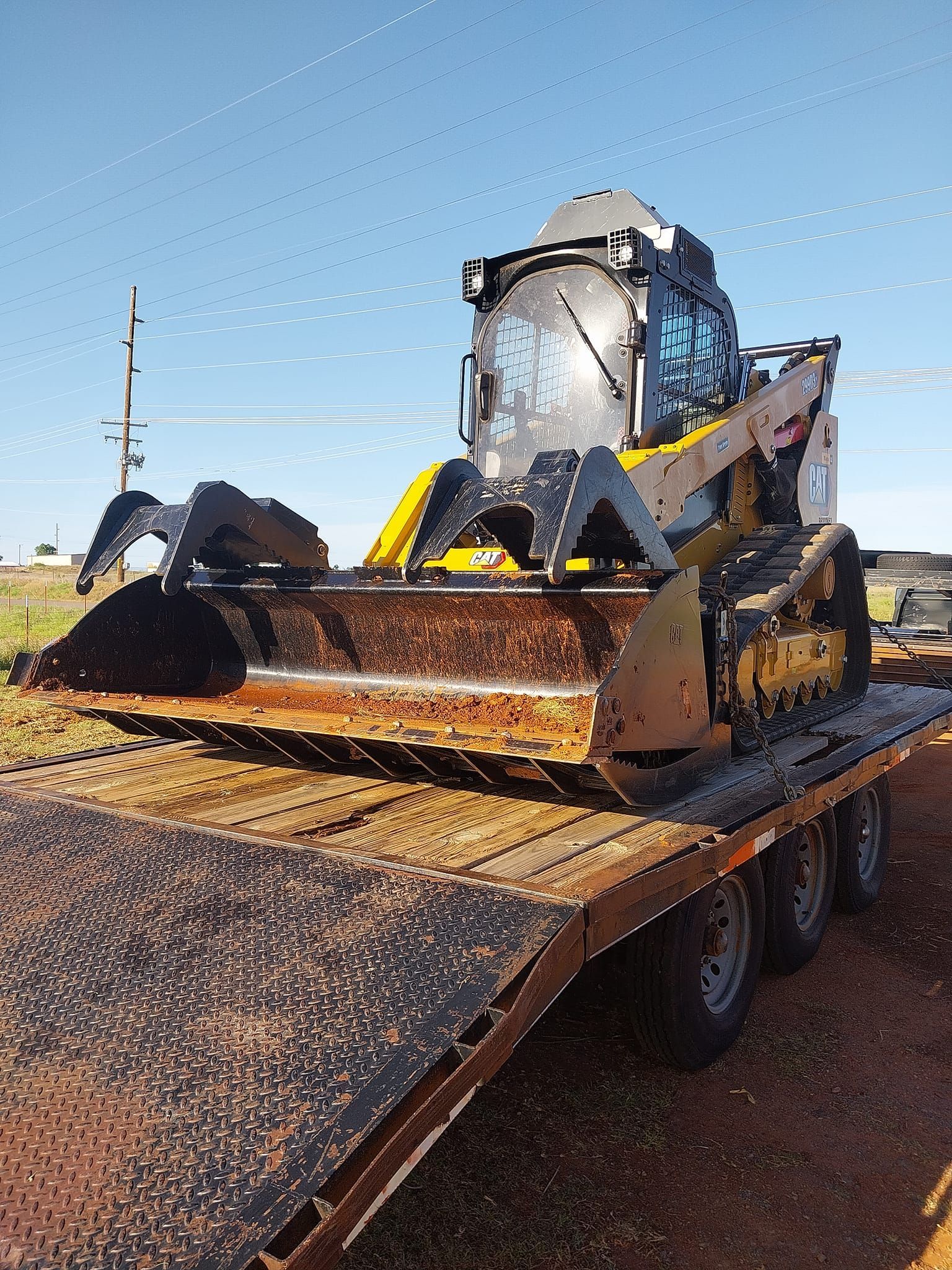 A bulldozer is sitting on top of a trailer.