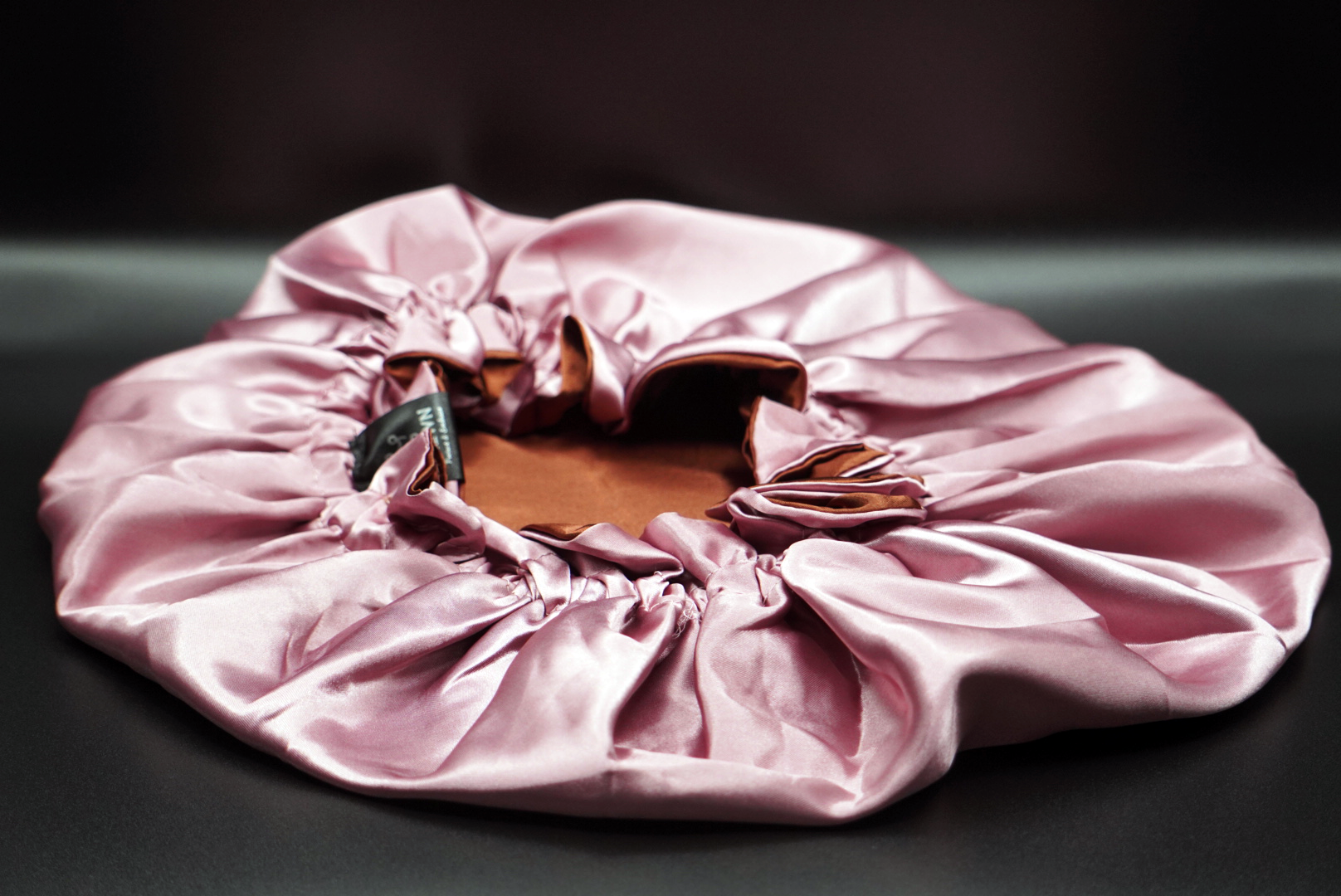 Satin-lined adult bonnet in cocoa rose, adjustable and reversible for hair protection