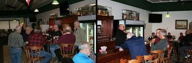 A group of people are sitting at tables in a restaurant.