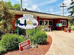 A red building with a sign in front of it that says hibbing tourist center.